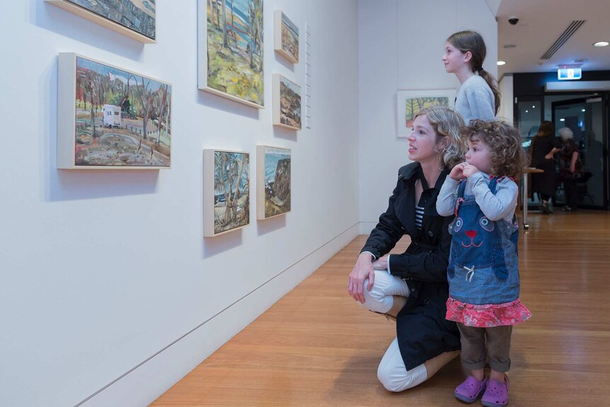 A family inspect work at Coffs Harbour Regional Gallery.