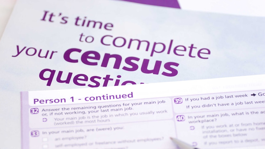 Pen over purple and white census forms.