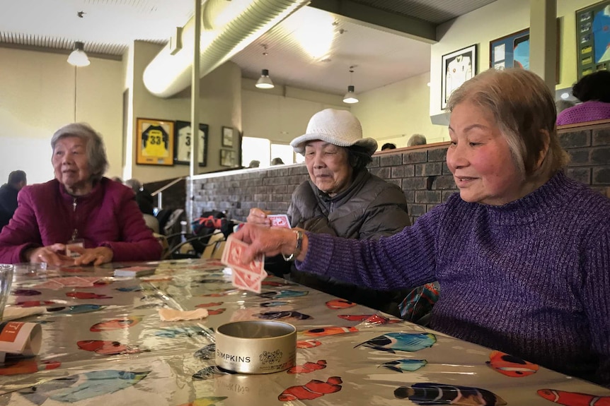 Visitors to Chung Wah aged care play cards