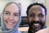 A picture of a white woman with blue eyes and a headscarf next to a Somali man smiling. He appears to have a cataract on one eye