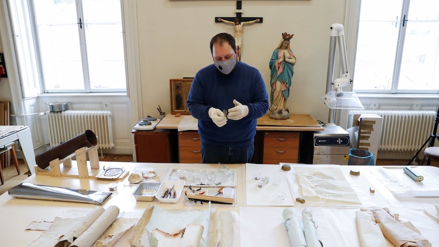 Paper items from the time capsule laid out on a table.