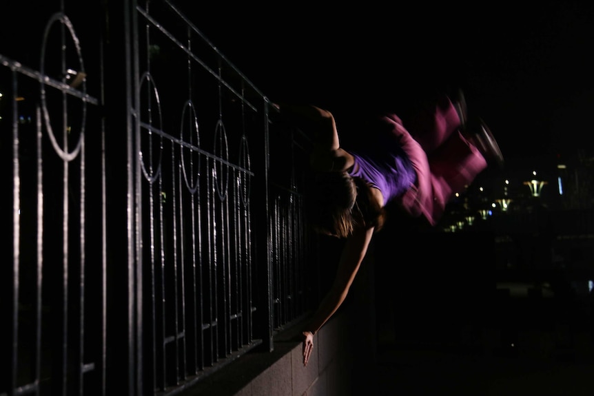 Australian Parkour Association Amy Han balances on one hand in Melbourne.