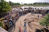 Flood victims queue for aid