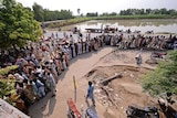 Flood victims queue for aid