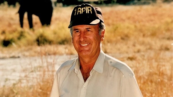 Experienced pilot Dick Lang stands in a field.