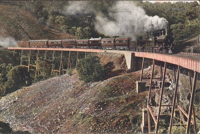 A train crosses the Sleep's viaduct in the Adelaide Hills puffing smoke