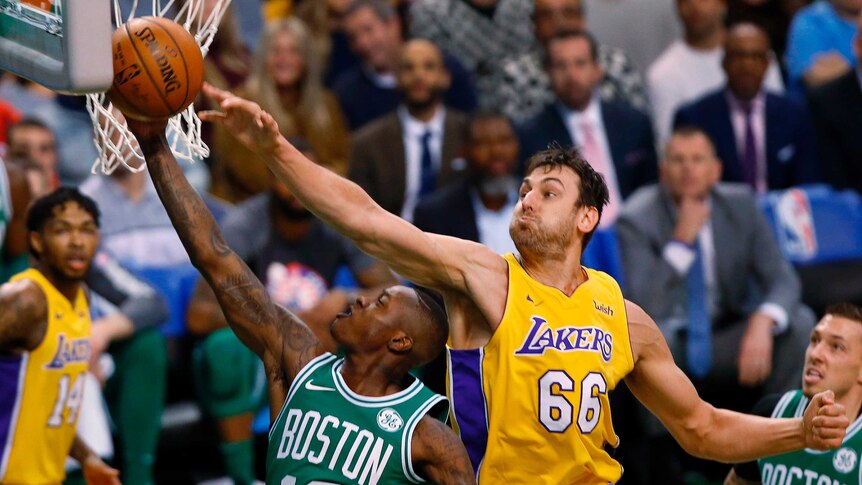 Boston Celtics' Terry Rozier (12) goes to the basket past Los Angeles Lakers' Andrew Bogut.