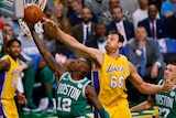 Boston Celtics' Terry Rozier (12) goes to the basket past Los Angeles Lakers' Andrew Bogut.
