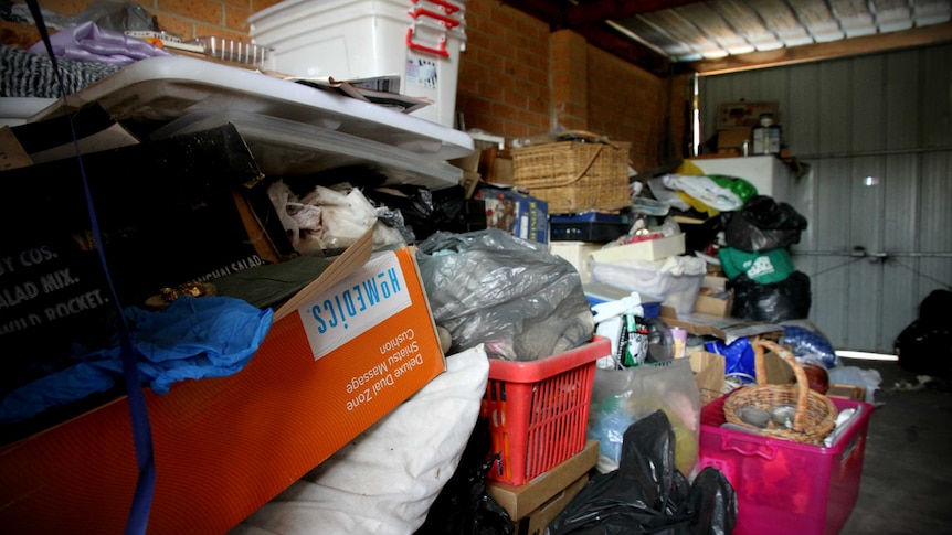 A large pile of stuff in a garage.