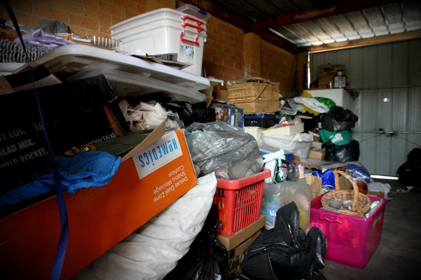 A large pile of stuff in a garage.