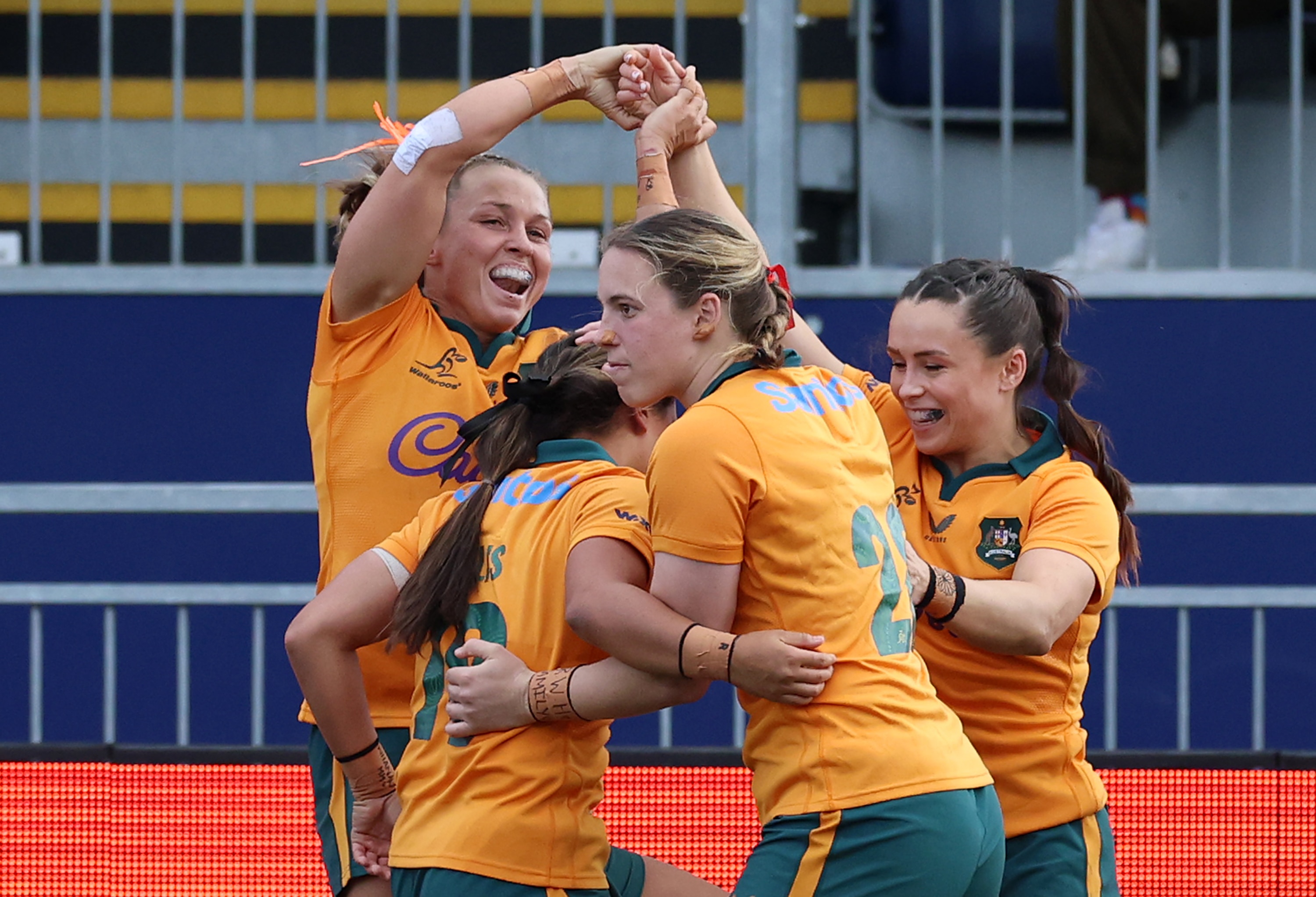 Wallaroos players celebrate a try against Scotland.
