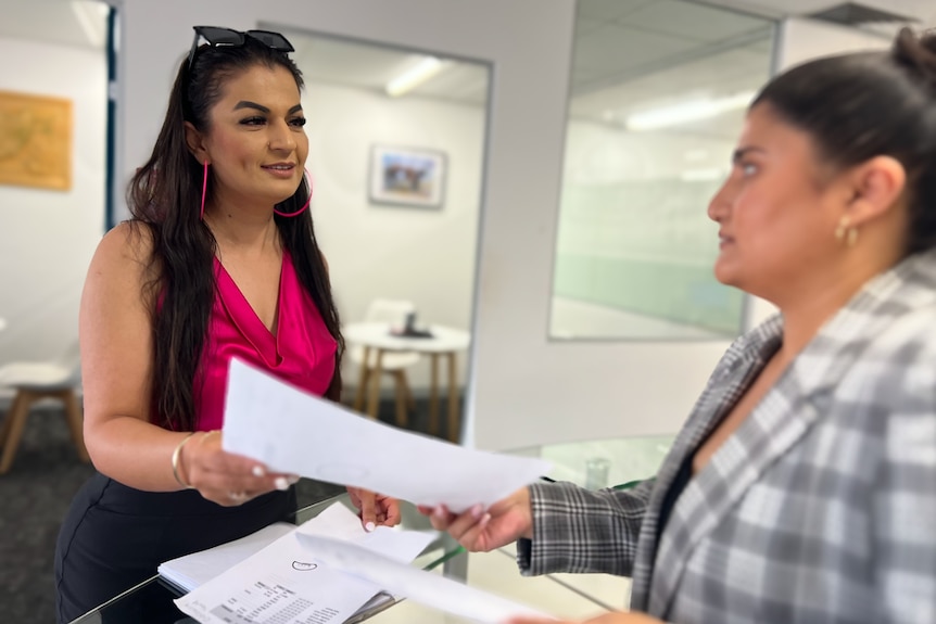 Tahera speaking to a staff member in her Western Sydney office