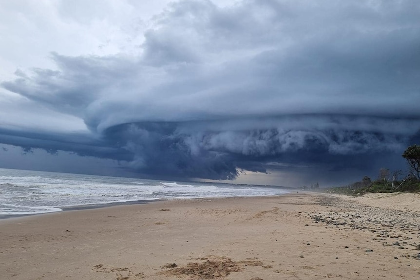 dark, stormy clouds above a grim looking beach