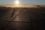 Sun rises over misty paddocks and the Numurkah solar farm