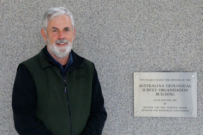 Don Fletcher by a plaque at the building.