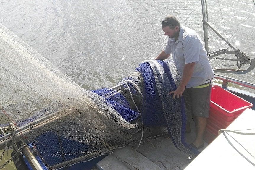 Mr Wilkinson on his prawn fishing boat at Bulimba Creek, in the Brisbane suburb of Hemmant.