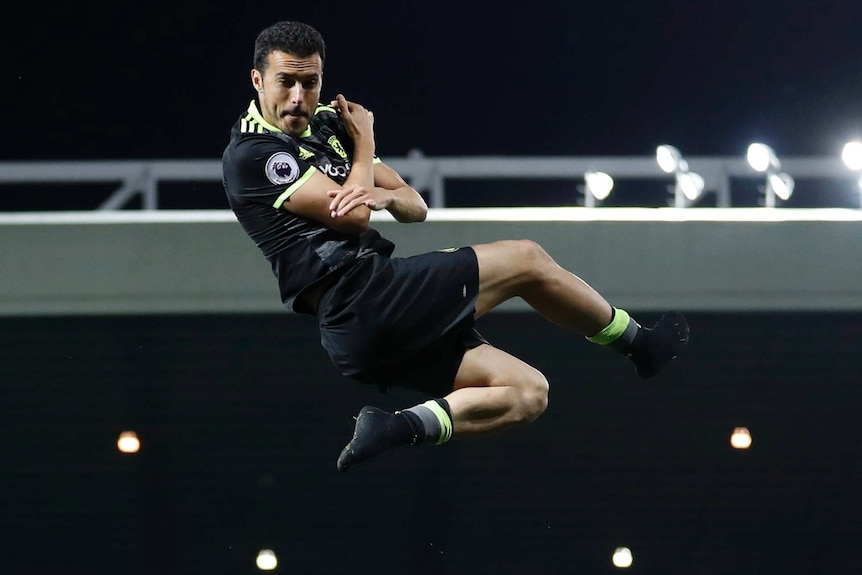 Pedro is thrown in the air by his Chelsea team-mates during their celebrations.