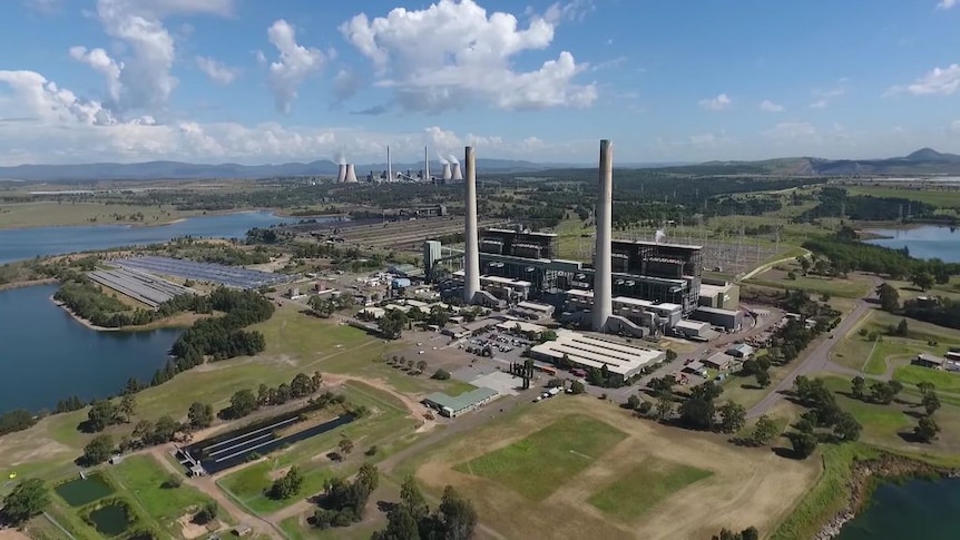 Aerial shot of the Liddell coal-fired power plant surrounded by lake and green fields