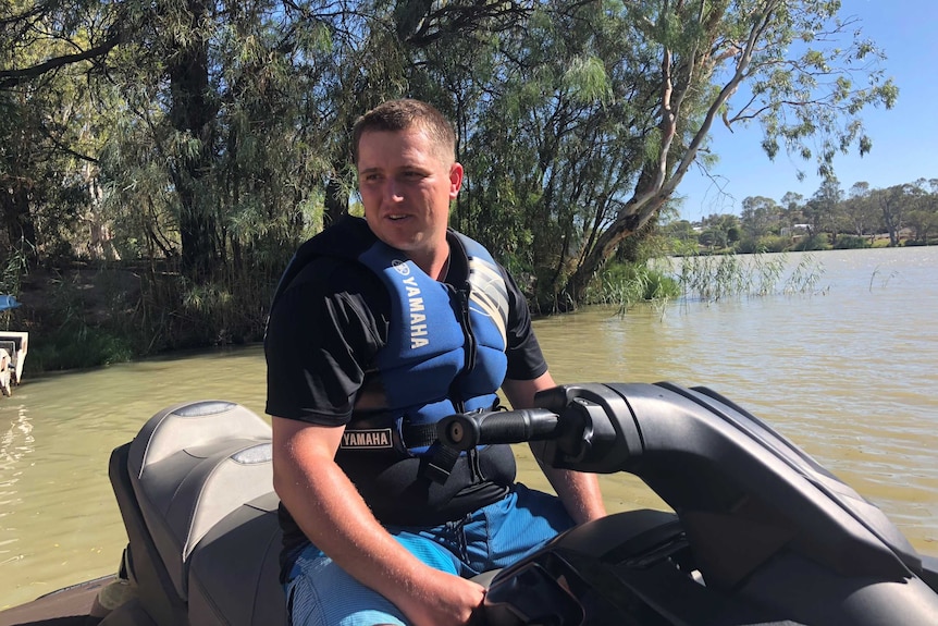 Glenn sits on a jet ski in the Murray River