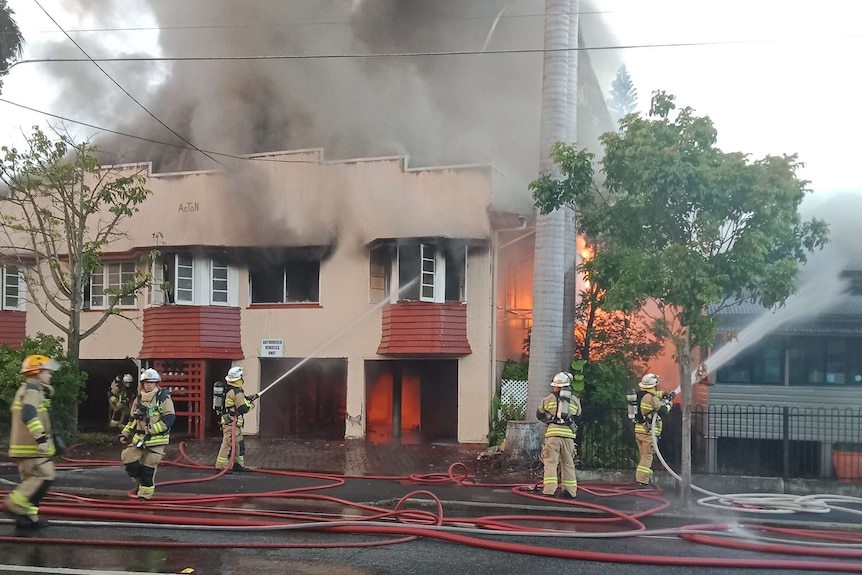 Fire crews fight a blaze that engulfed at boarding house at South Brisbane.