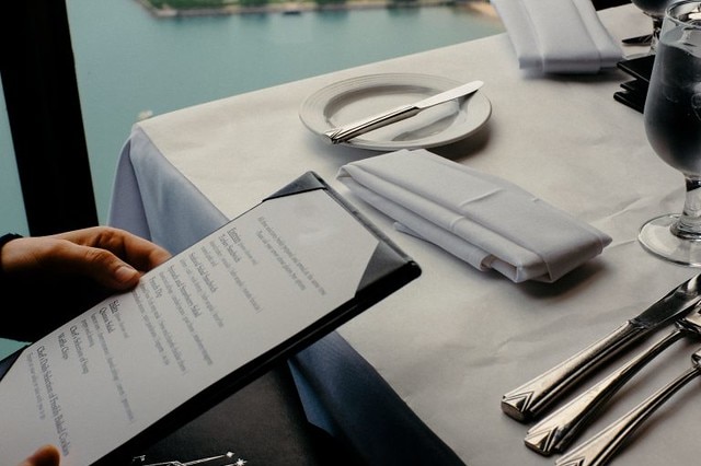 A person looking at a menu in a restaurant