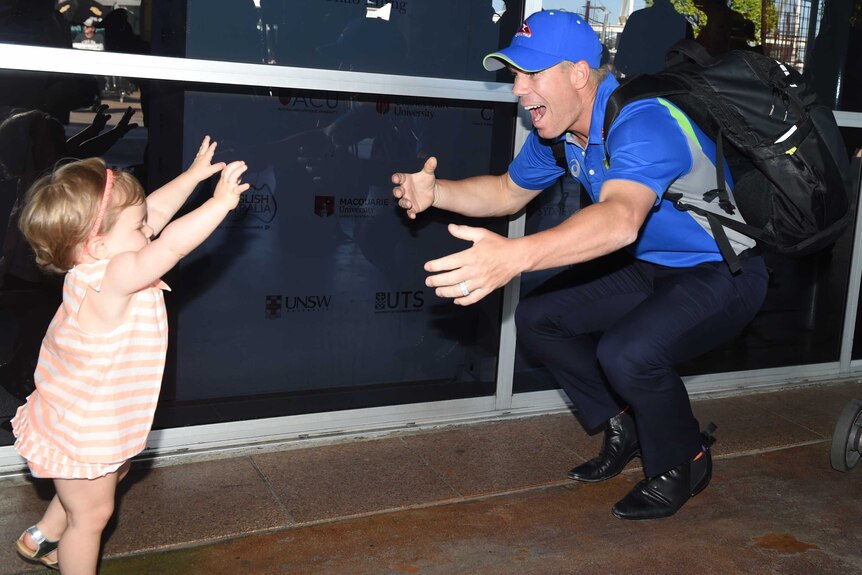 David Warner greets his daughter at the airport