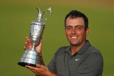 Francesco Molinari of Italy holds the trophy after winning the British Open title at Carnoustie.