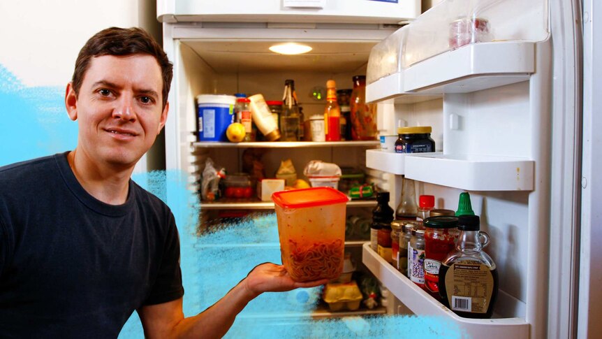 Pat Wright holds leftover spaghetti in front of an open fridge in story about storage tips for meals, dairy, vegetables, fruit.