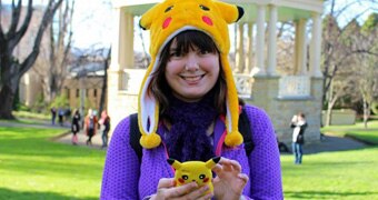 A Pokemon Go player with a Pikachu hat and phone case.