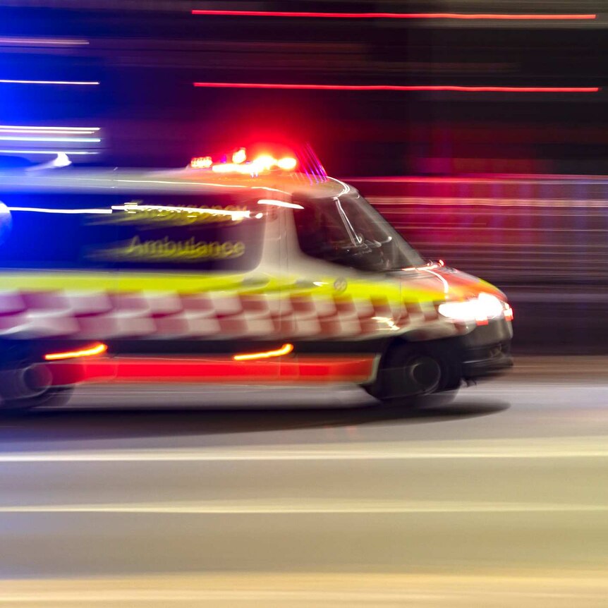 Partly burred image of an ambulance at night time