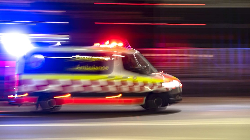 Partly burred image of an ambulance at night time