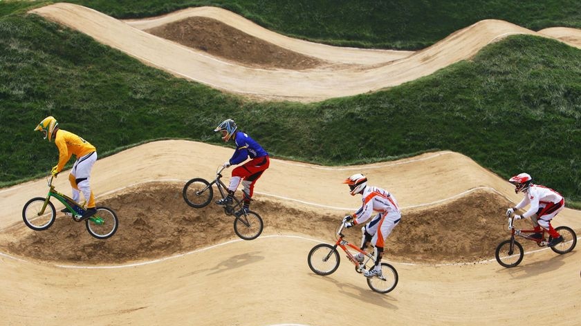 Competitors make their way around the course in the in the men's BMX quarter-finals