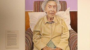 A portrait of Judy Cassab hangs in an art gallery