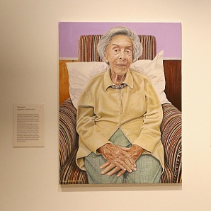 A portrait of Judy Cassab hangs in an art gallery