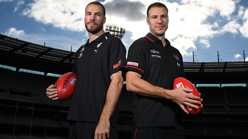 Harry McKay of Carlton (left) and Ben McKay of Essendon pose for a photograph at the MCG.