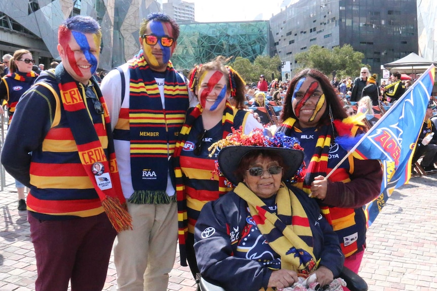 Adelaide Crows fans wear team colours in Federation Square before the game.