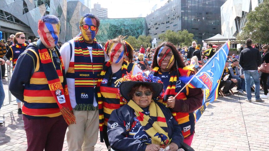 Adelaide Crows fans wear team colours in Federation Square before the game.