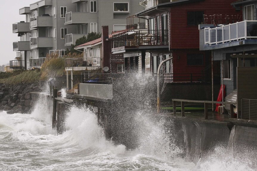 Waves pound waterfront homes in Seattle.