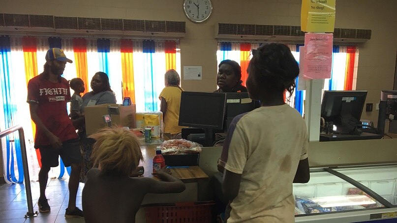 Residents in Ngukurr line up to buy food from the local general store.