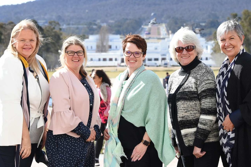 Five women stand together in Canberra after lobbying for better internet in regional Australia.