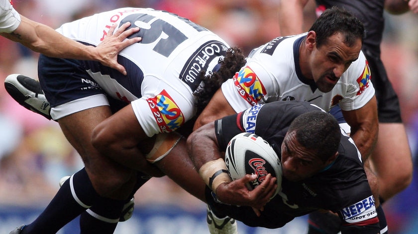 Petero Civoniceva gets tackled by Sam Thaiday and Tonie Carroll