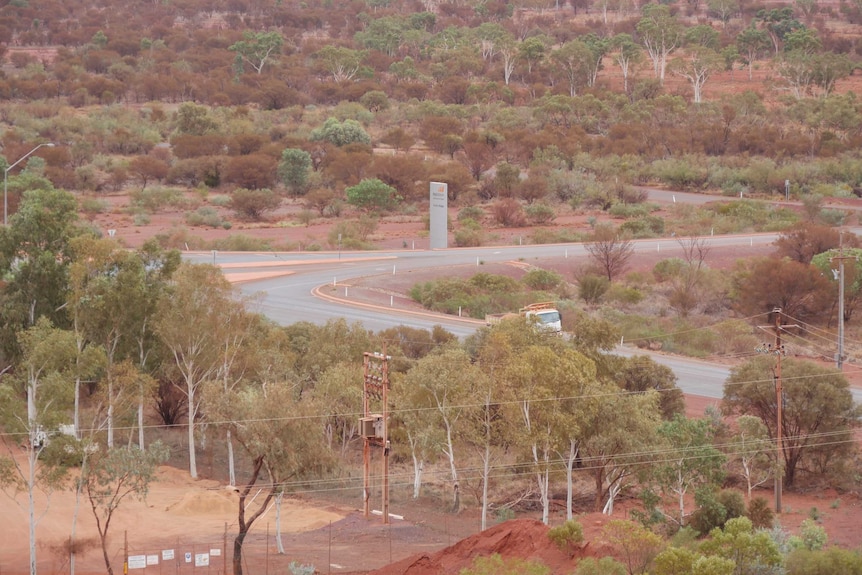 A road snakes between scrub and trees