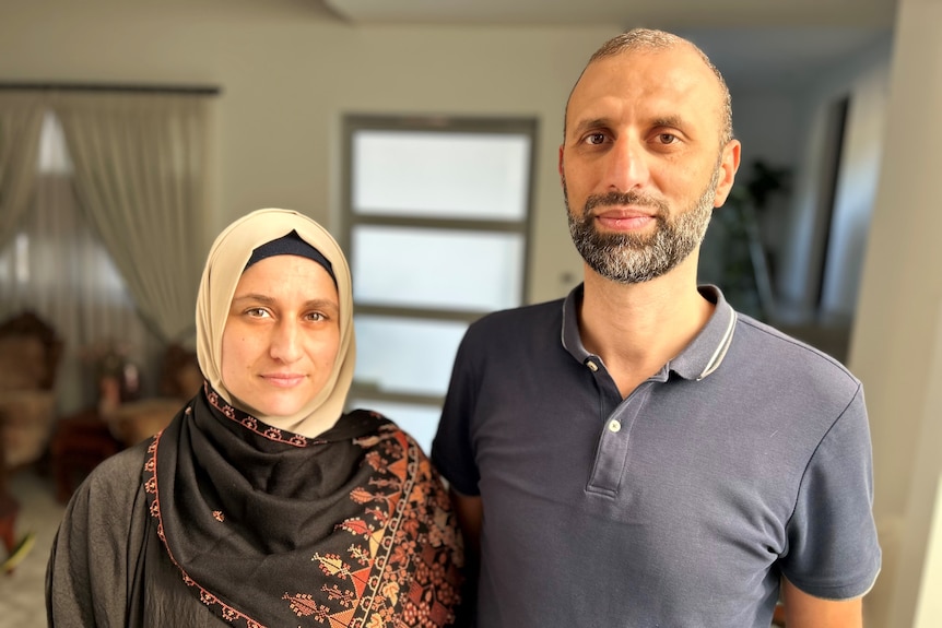 Forat Sultan, right, with his arm around wife Ramia Abdo Sultan inside their Sydney home