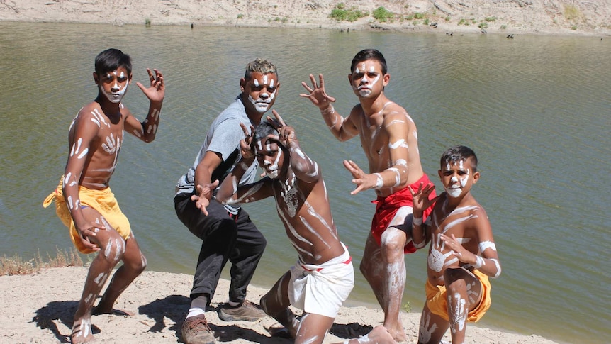 Members of the Barkindji dance troupe pose on the banks of the Darling River.