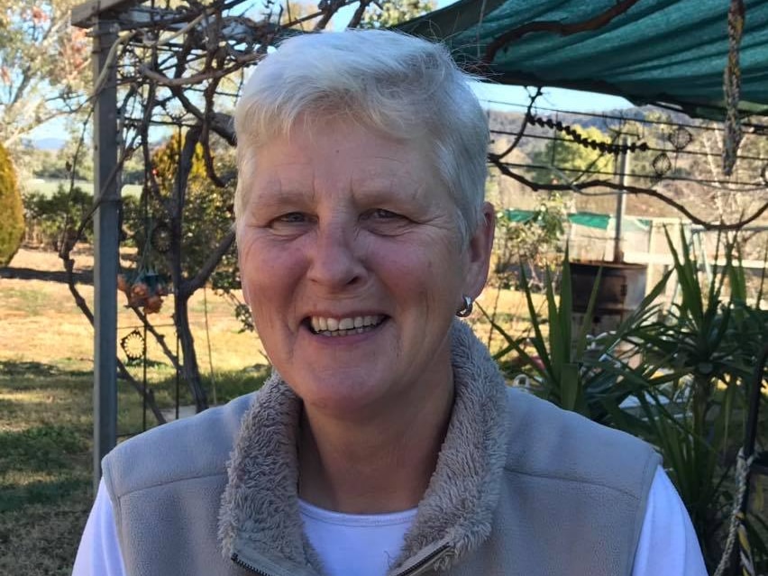 A woman with short white hair smiling