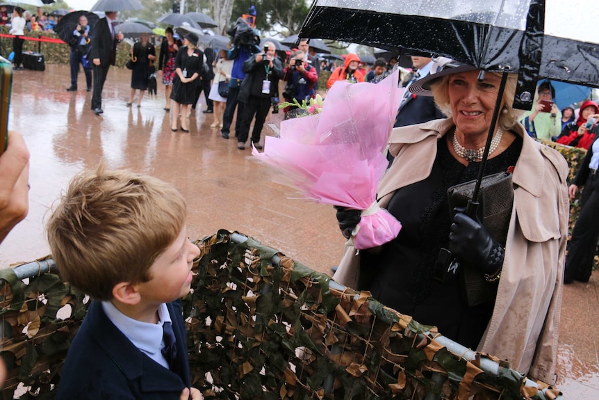 Darcy, 9, delivers a bouquet of flowers to Camilla, the Duchess of Cornwall.