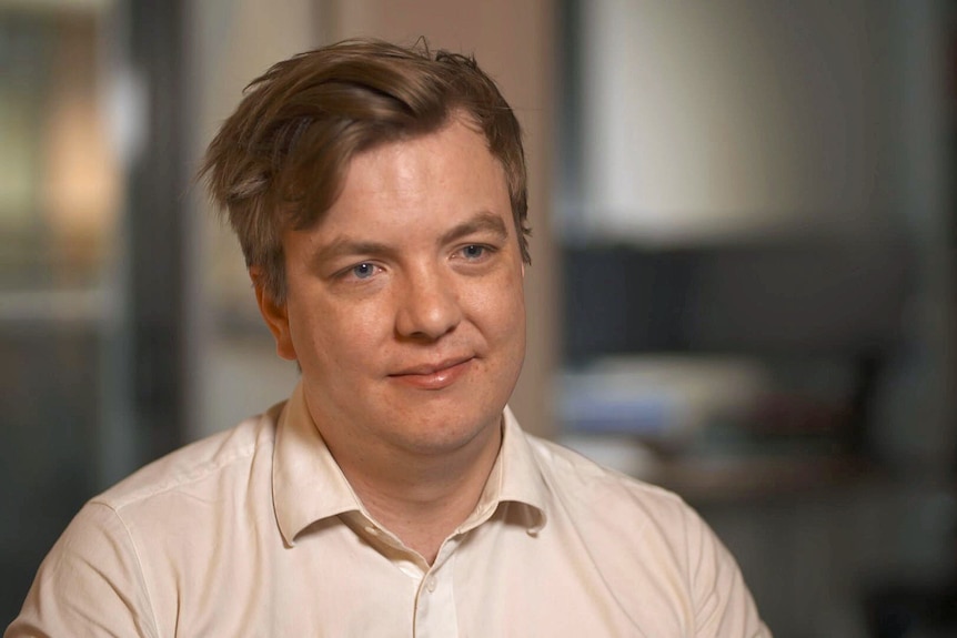 A young man wearing a white shirt.