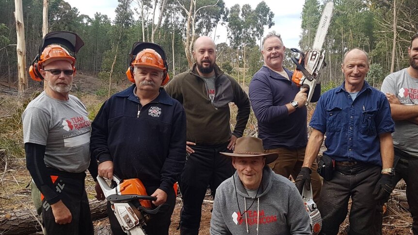 War veterans from Team Rubicon Australia completing community work with chainsaws