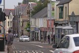 Taxi drives down street in Welsh town of Bridgend
