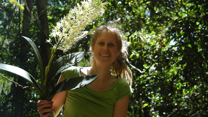 woman holds plant